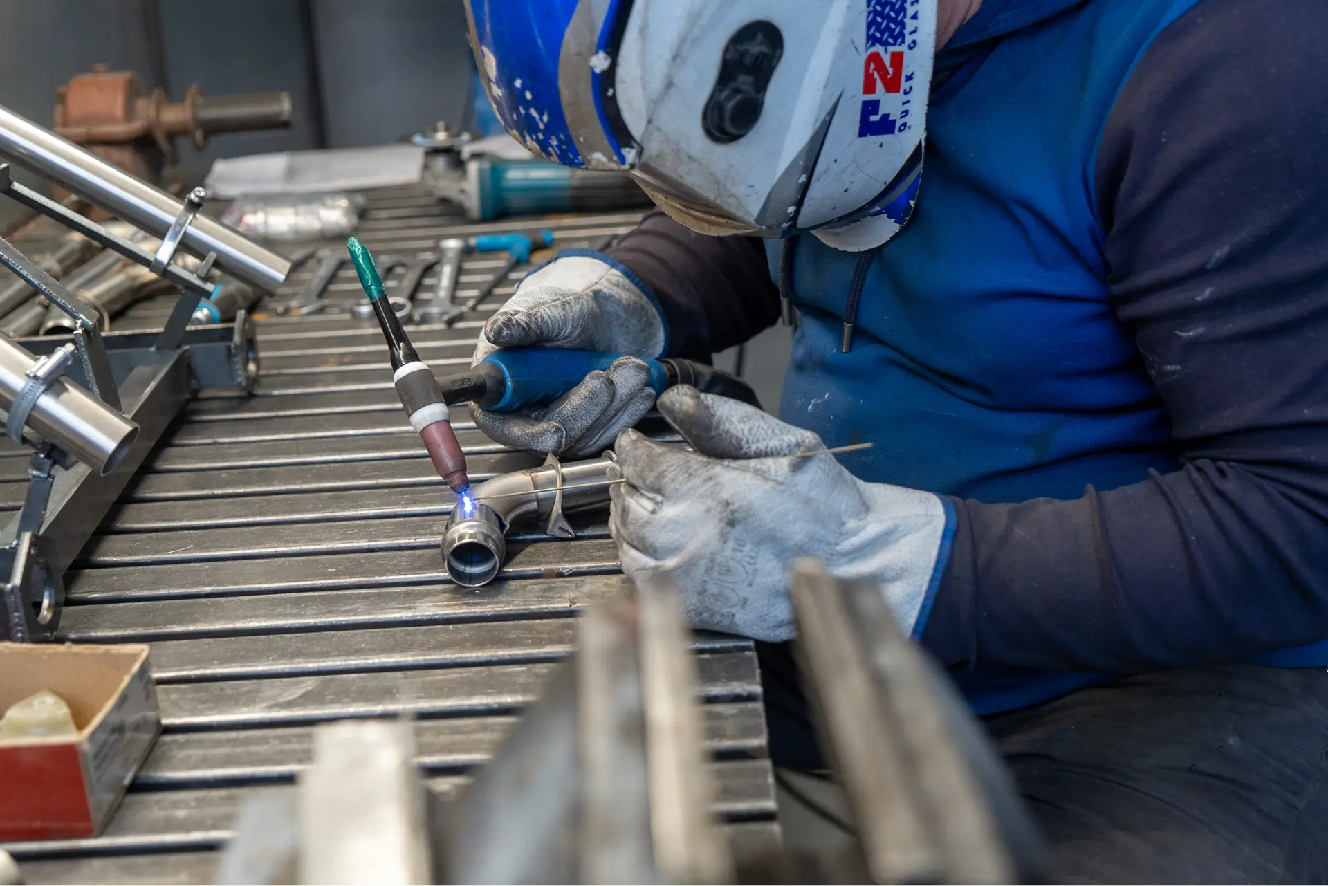Technician TIG welding a stainless steel aircraft component at Belmont