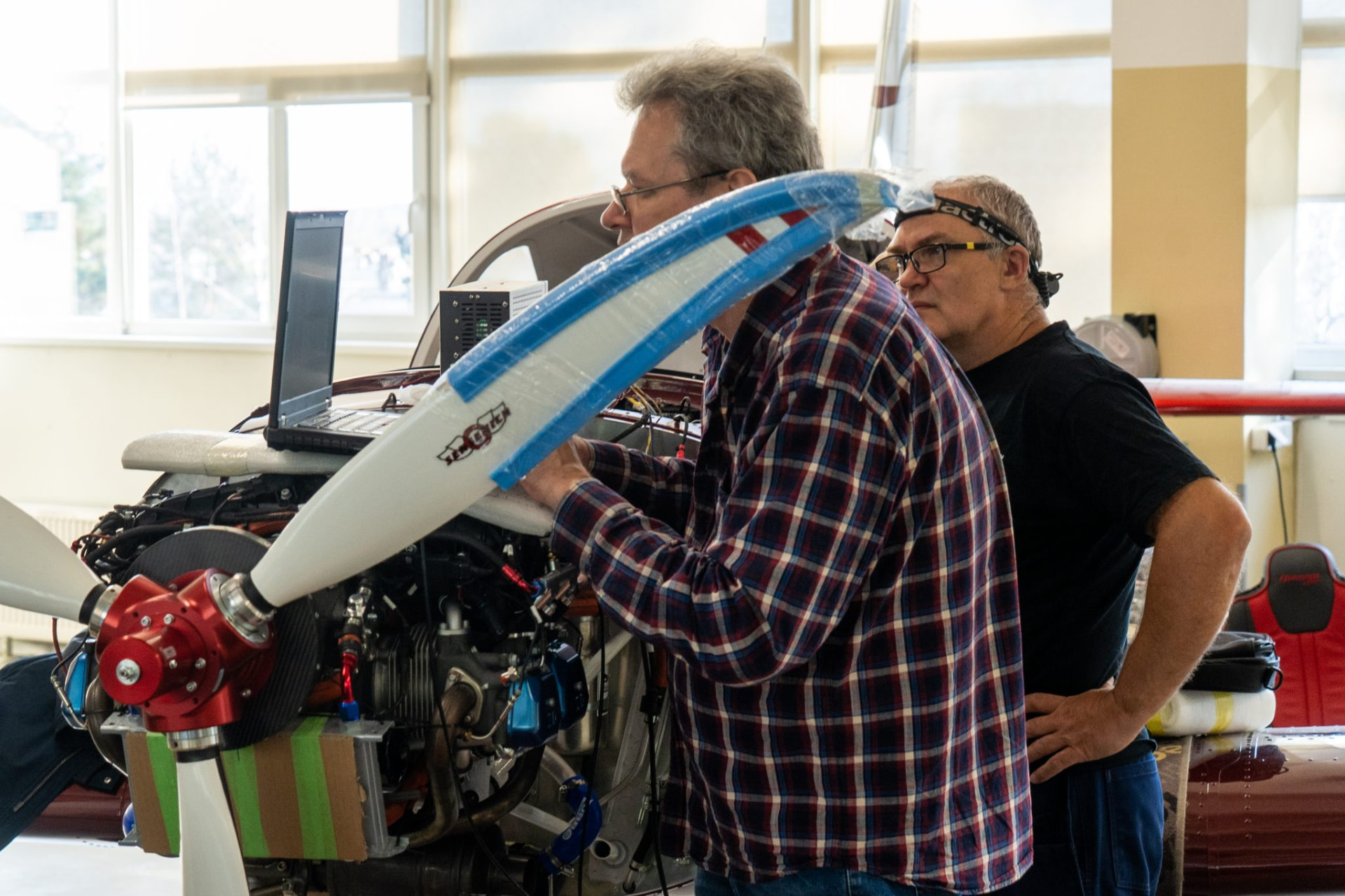 Belmont engineers inspecting engine and propeller